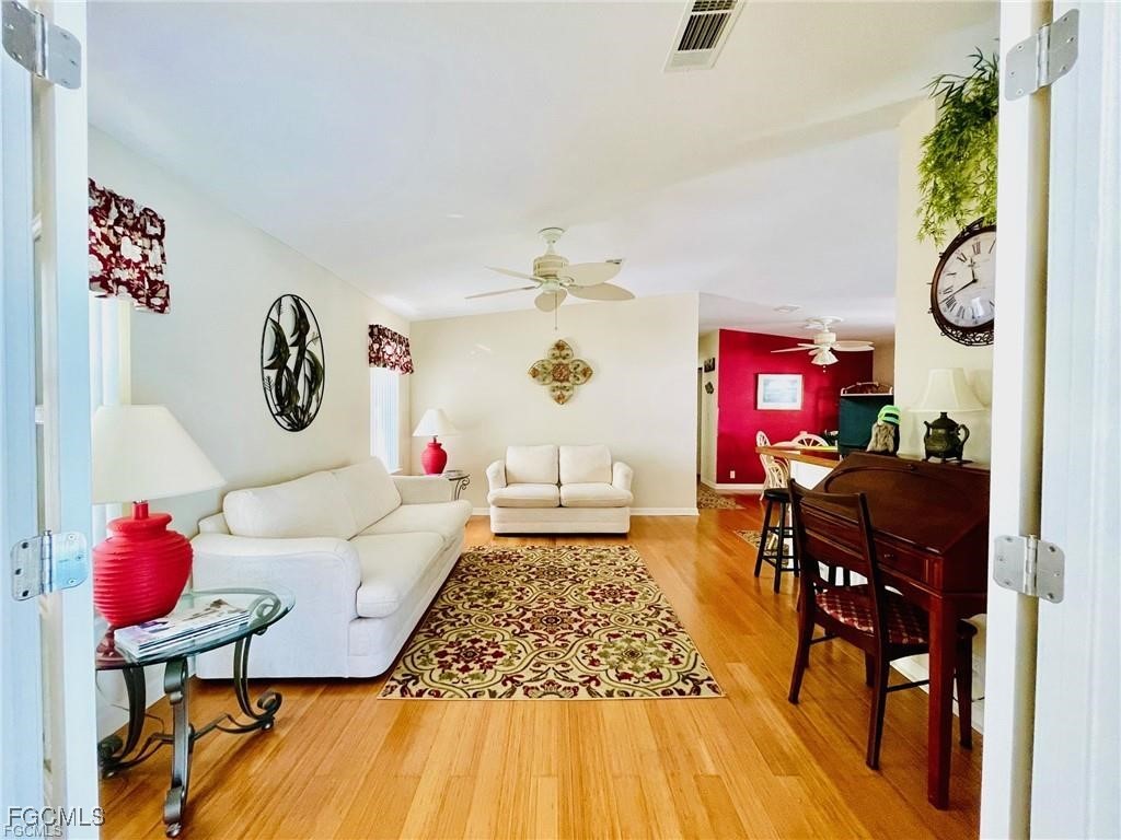 3064 Sloop Lane St. James City, FL 33956 - Photo 19 of 30 a living room with furniture and a chandelier