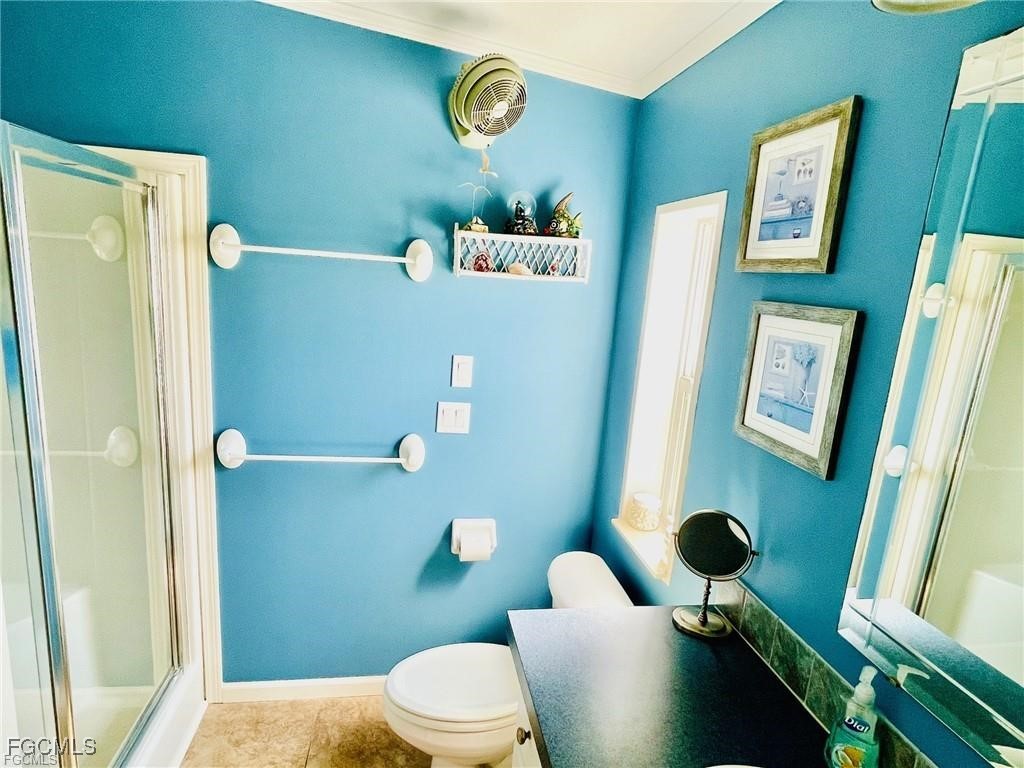 3064 Sloop Lane St. James City, FL 33956 - Photo 20 of 30 a bathroom with a toilet sink and shower curtain