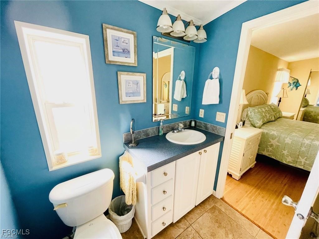 3064 Sloop Lane St. James City, FL 33956 - Photo 21 of 30 a bathroom with a double vanity sink mirror and toilet