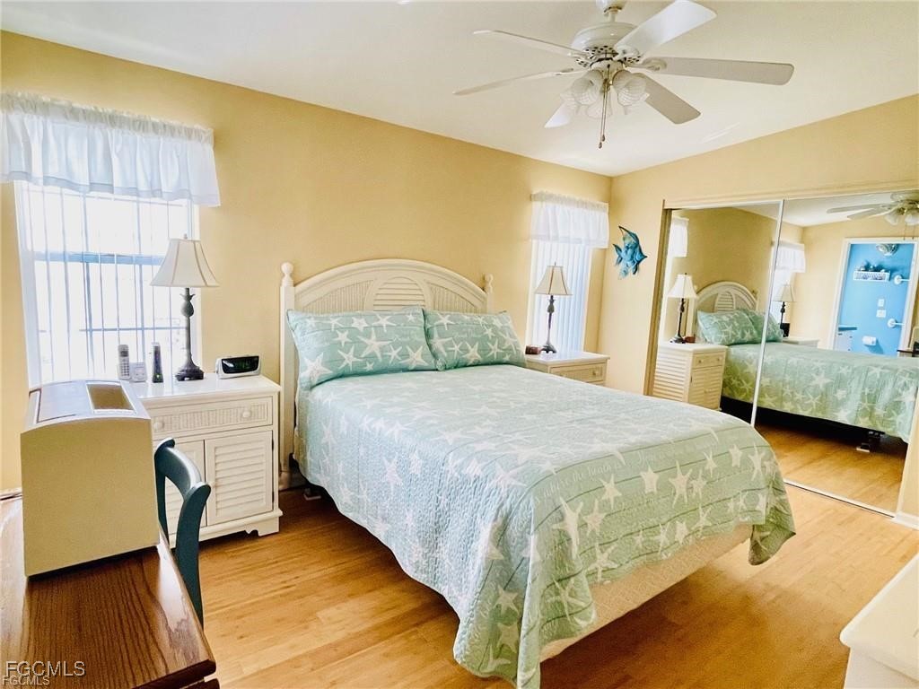 3064 Sloop Lane St. James City, FL 33956 - Photo 22 of 30 a bedroom with a bed and a chandelier