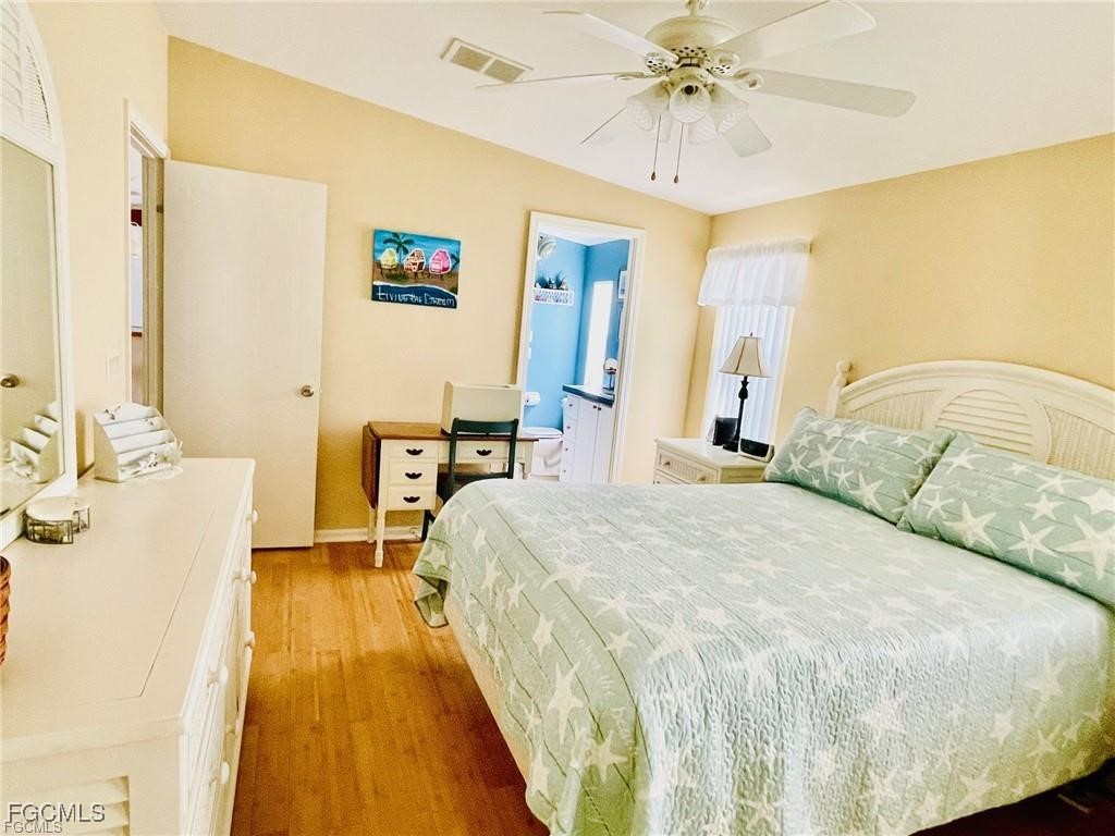 3064 Sloop Lane St. James City, FL 33956 - Photo 23 of 30 a bedroom with a bed and a chandelier