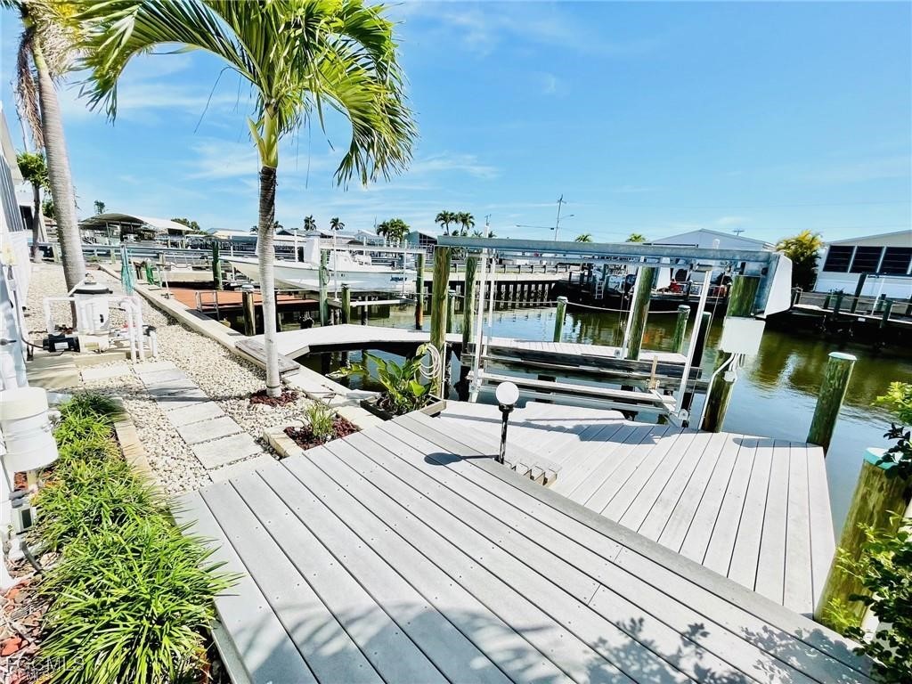 3064 Sloop Lane St. James City, FL 33956 - Photo 4 of 30 a view of roof deck with a barbeque and wooden stairs