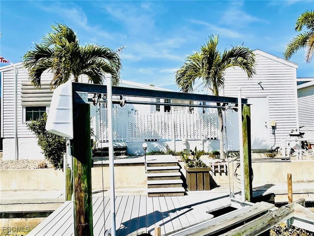 3064 Sloop Lane St. James City, FL 33956 - Photo 5 of 30 a view of a balcony with potted plants and palm trees