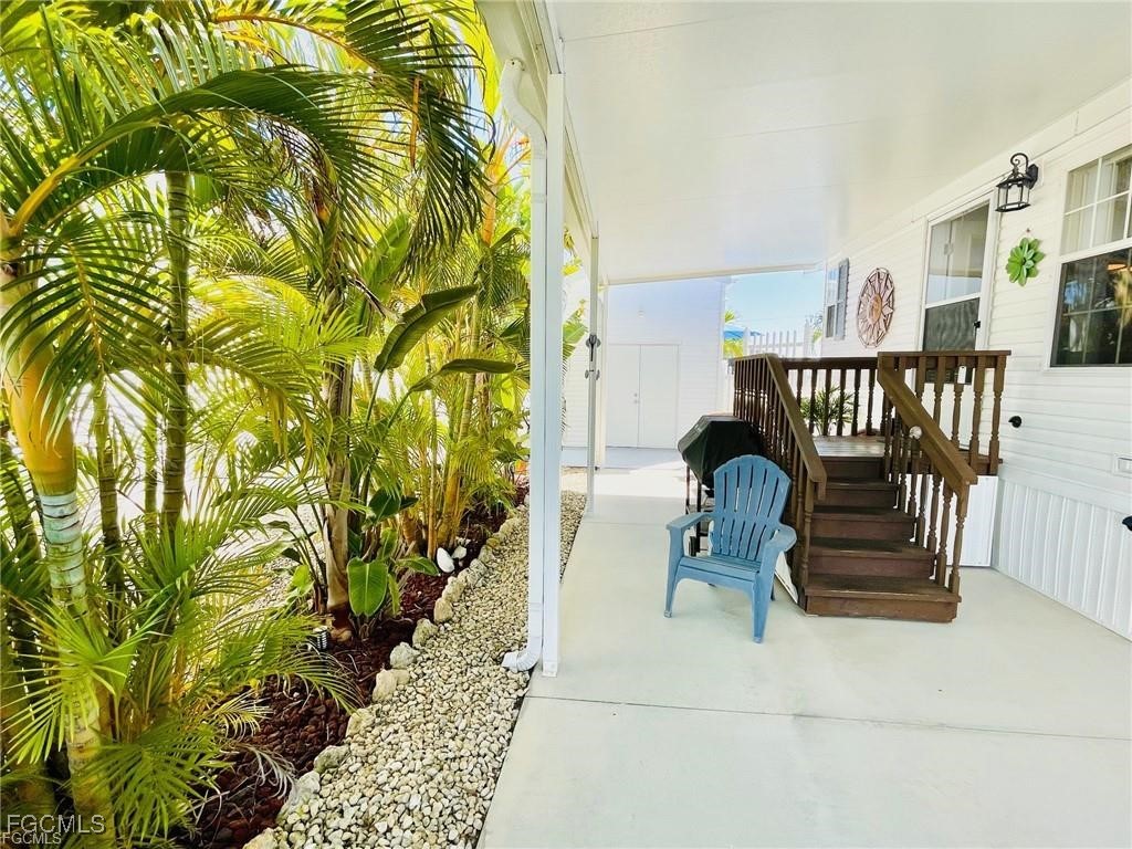 3064 Sloop Lane St. James City, FL 33956 - Photo 8 of 30 a balcony with potted plants and wooden fence