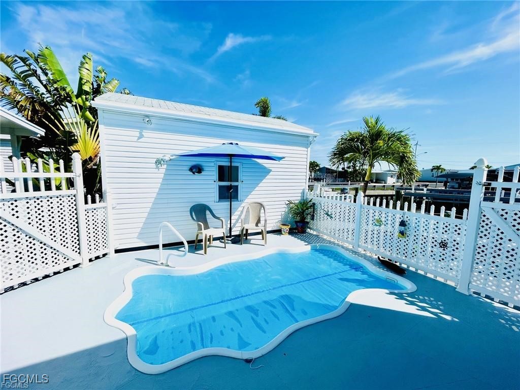 3064 Sloop Lane St. James City, FL 33956 - Photo 10 of 30 a front view of a house with deck