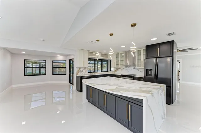 a kitchen with stainless steel appliances a refrigerator sink and stove