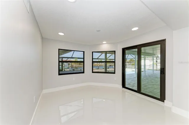 a front view of a house with a garden and tree