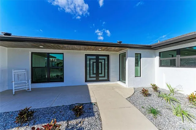a view of an empty room with window and a kitchen