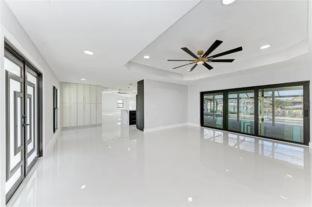 a kitchen with a sink and a stove with wooden floor