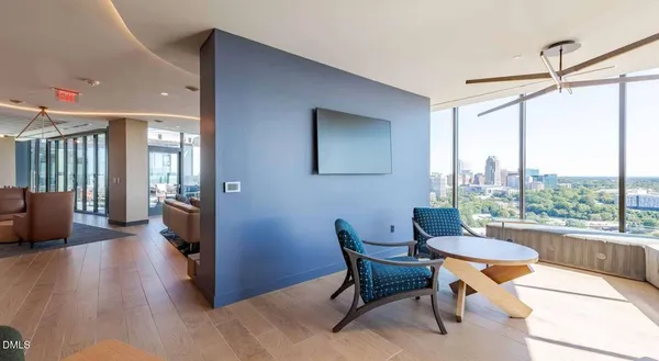 a living room with furniture flat screen tv and a large window
