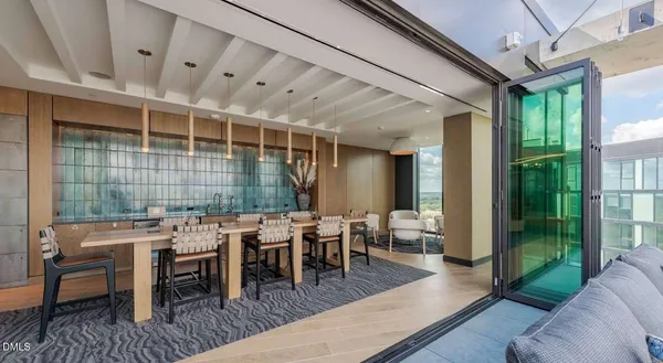 a living room with furniture a flat screen tv and a large window
