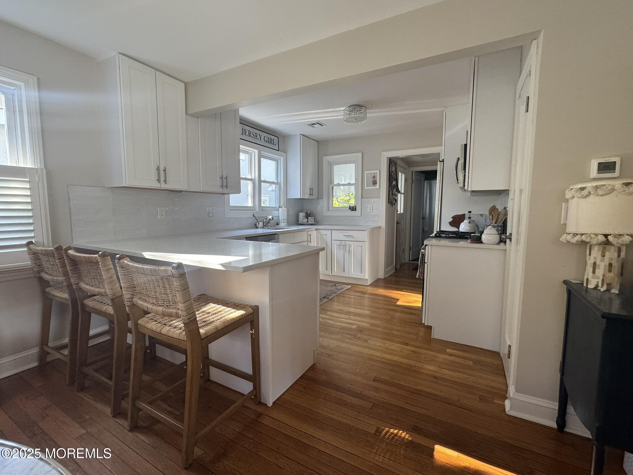 59 Leroy Place Red Bank, NJ 07701 - Photo 11 of 37 a kitchen with stainless steel appliances granite countertop a table chairs sink and cabinets