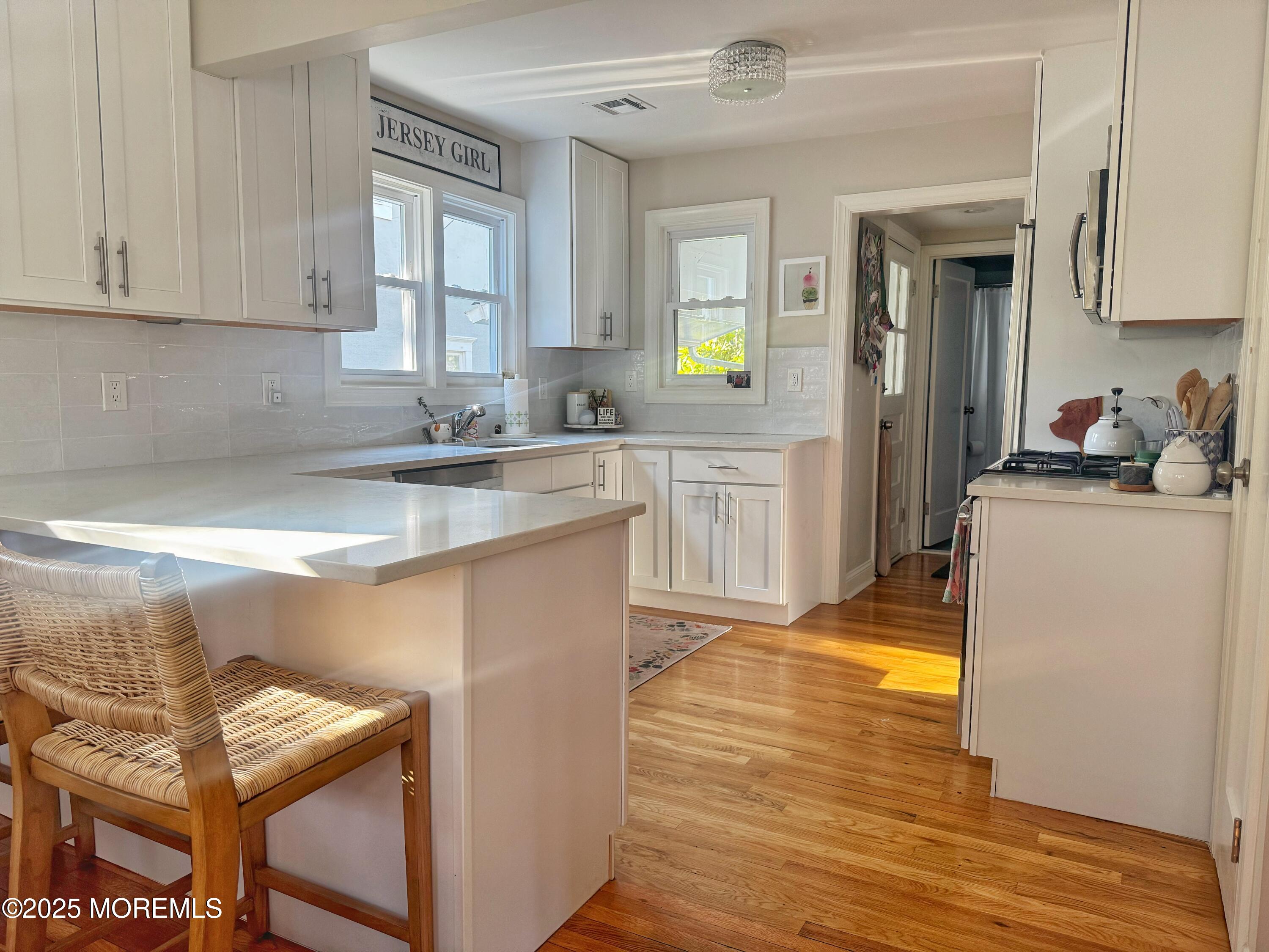 59 Leroy Place Red Bank, NJ 07701 - Photo 12 of 37 a kitchen with stainless steel appliances granite countertop a sink stove and cabinets