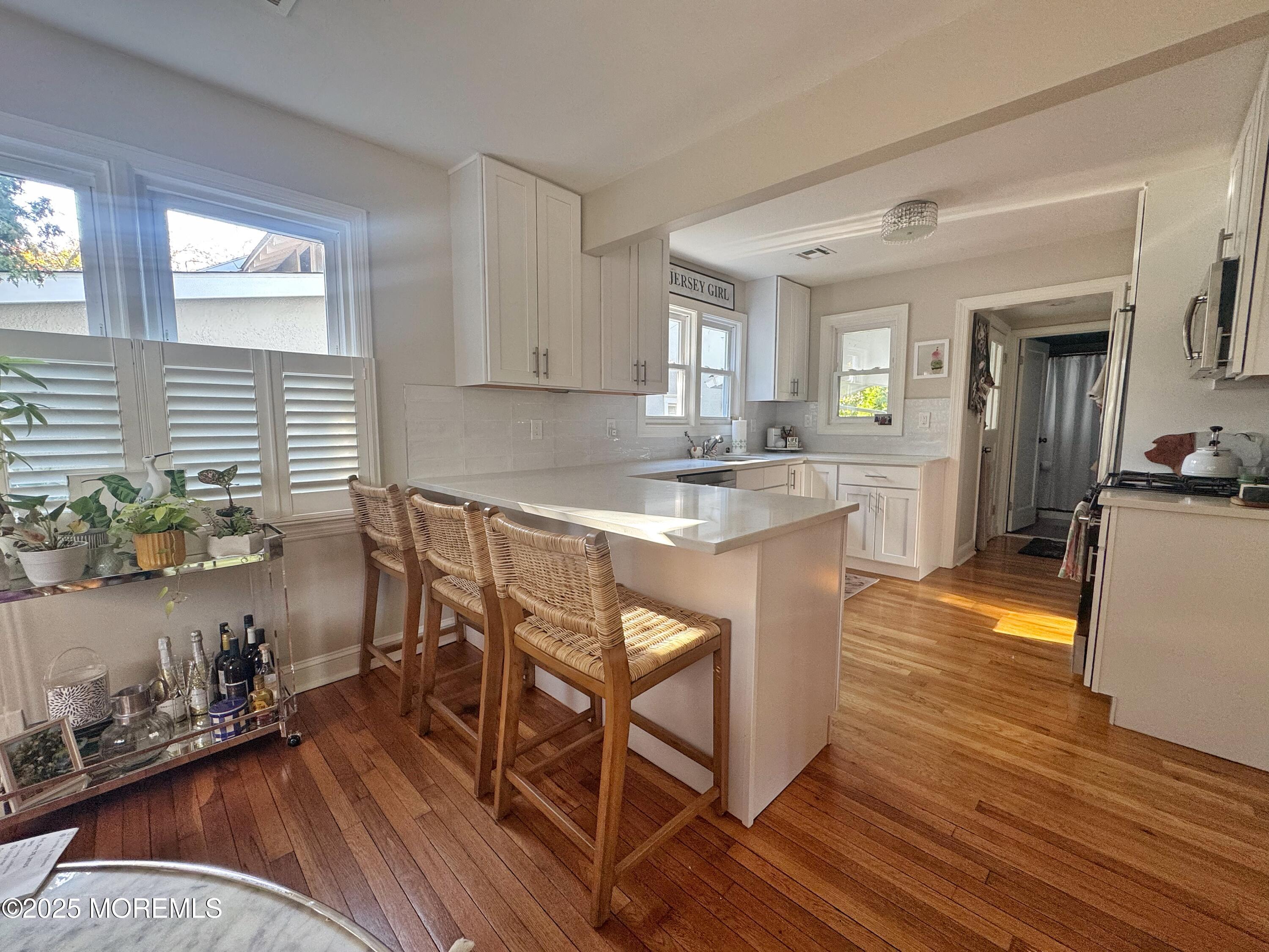 59 Leroy Place Red Bank, NJ 07701 - Photo 14 of 37 a kitchen with stainless steel appliances a dining table chairs stove refrigerator and cabinets