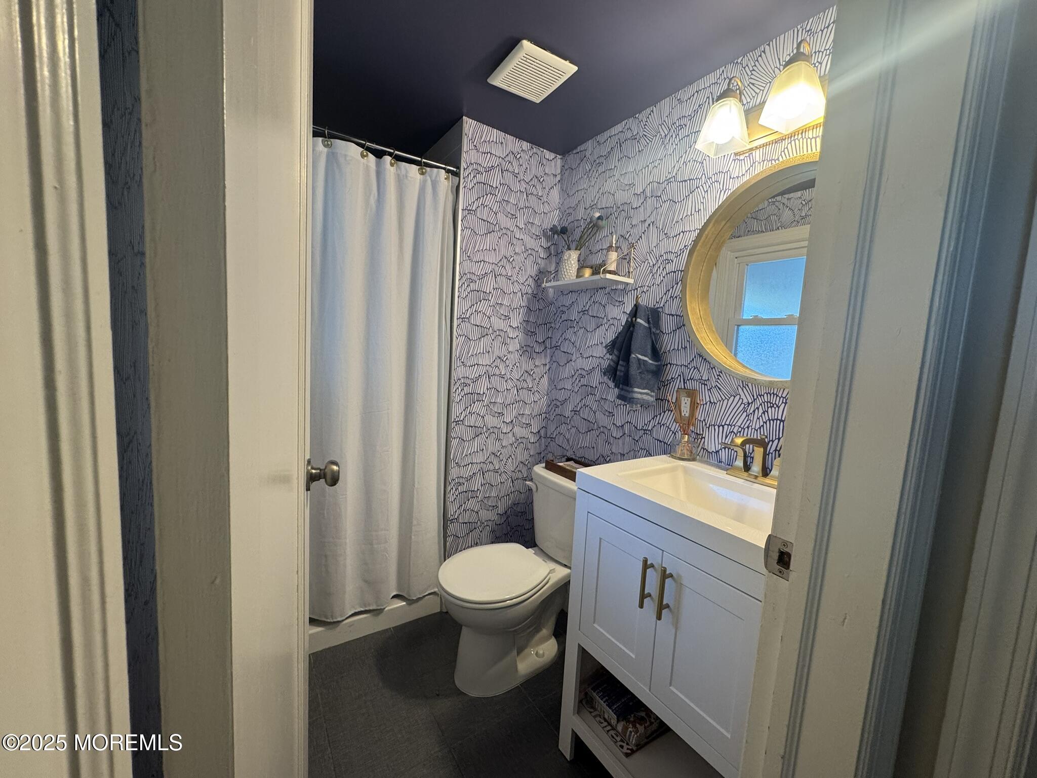 59 Leroy Place Red Bank, NJ 07701 - Photo 19 of 37 a bathroom with a toilet a sink and a mirror