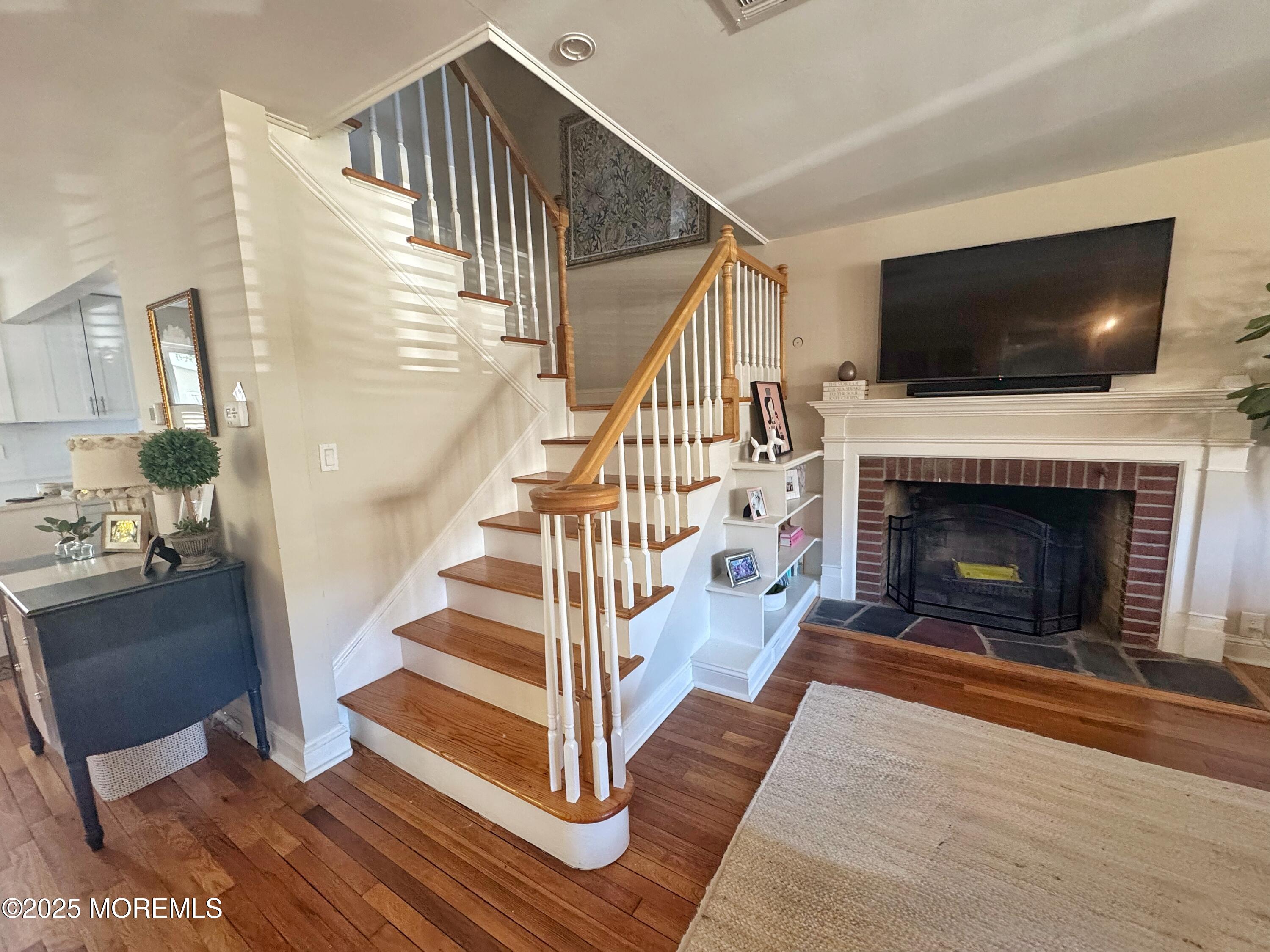 59 Leroy Place Red Bank, NJ 07701 - Photo 8 of 37 a view of a livingroom with wooden floor fireplace and a rug
