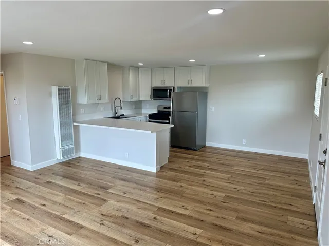 a view of kitchen with wooden floor