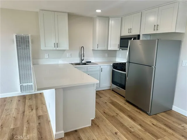 a kitchen with wooden cabinets and stainless steel appliances