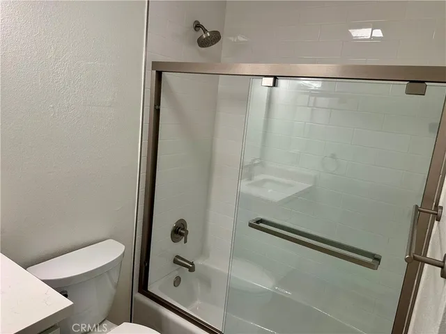 a bathroom with a shower and a toilet
