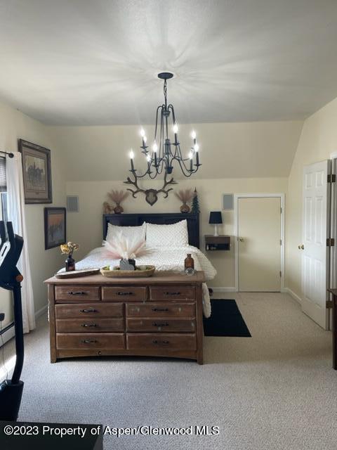 1535 Anvil View Avenue Rifle, CO 81650 - Photo 13 of 21 a spacious bedroom with a bed and chandelier