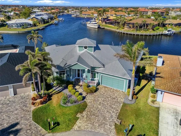 an aerial view of a house with yard lake and ocean view
