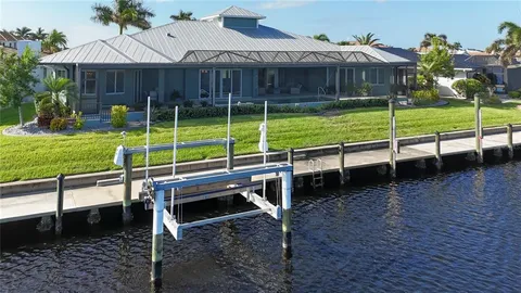 an aerial view of a house with yard lake and ocean view