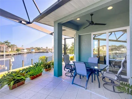 a bedroom with a large bed and large windows