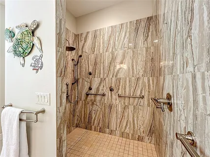 a bathroom with a granite countertop shower and a sink
