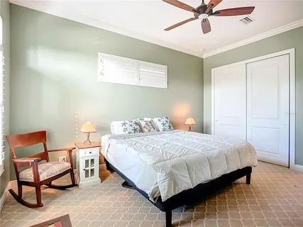 a view of a white building next to a yard