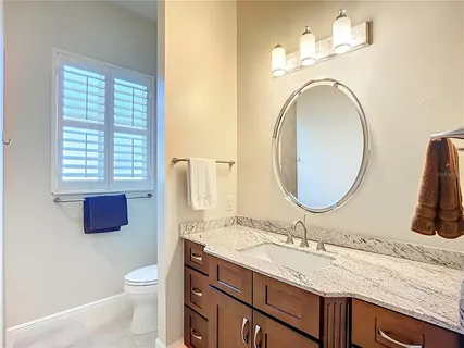 a view of a lake with a table and chairs under an umbrella next to a yard