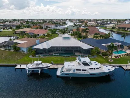 an aerial view of a house with a garden and lake view