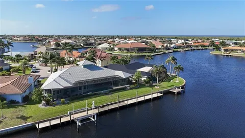 a view of a house with yard and sitting area