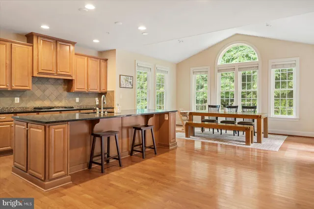 a living room with furniture a fireplace and a large window