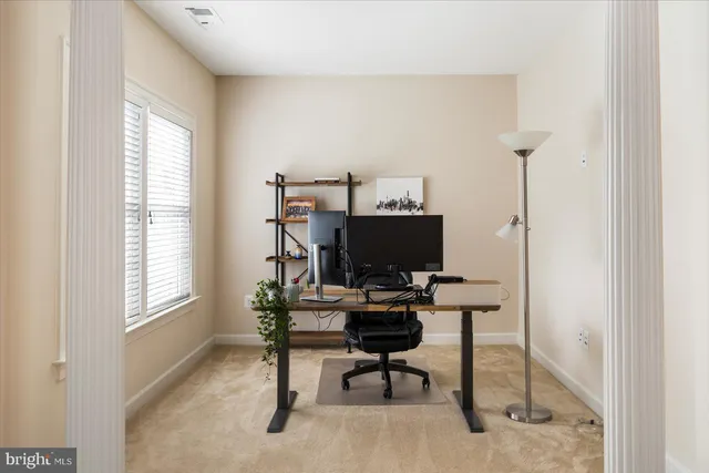 a bedroom with a large bed couch and window