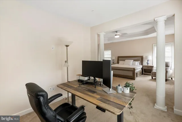 a spacious bedroom with a bed and a chandelier