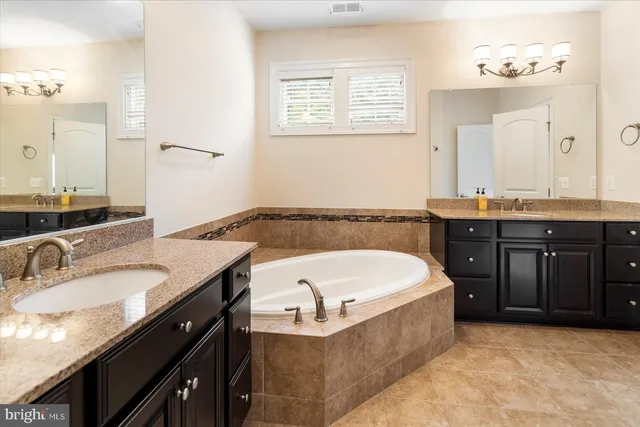 a bathroom with a granite countertop sink and vanity