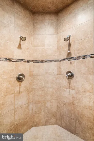 a spacious bathroom with a granite countertop sink a mirror and a bathtub