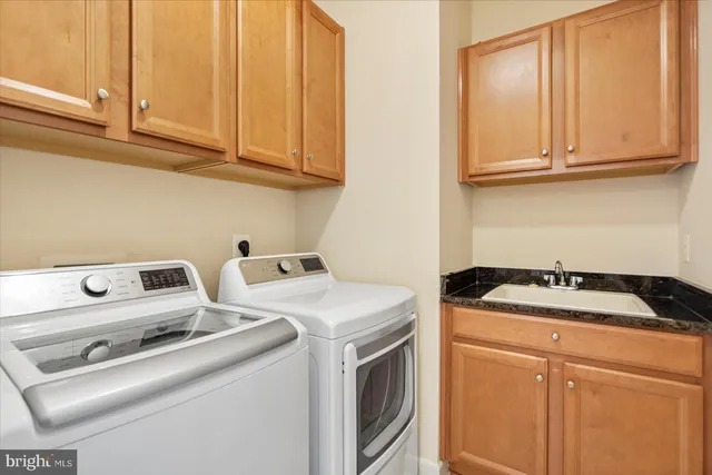 a view of a house with a big yard plants and large trees
