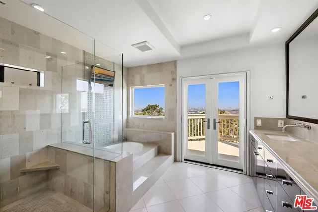a spacious bathroom with a tub shower and sink