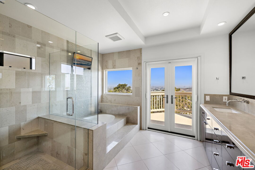 31 St Tropez Newport Beach, CA 92660 - Photo 13 of 22 a spacious bathroom with a tub shower and sink