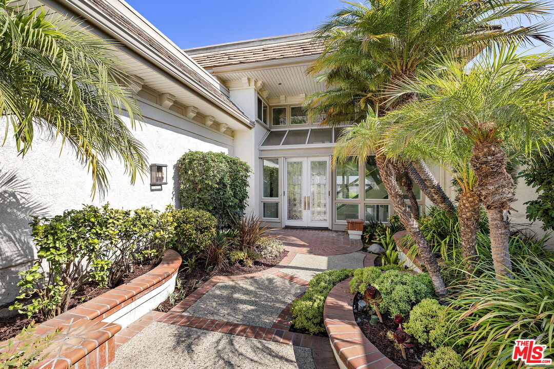 31 St Tropez Newport Beach, CA 92660 - Photo 18 of 22 a front view of a house with a yard