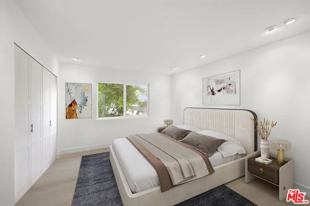 a bedroom with a large bed and a window