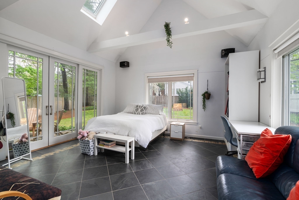 51 Avon Road Wellesley, MA 02482 - Photo 12 of 26 a spacious bedroom with a bed and glass window