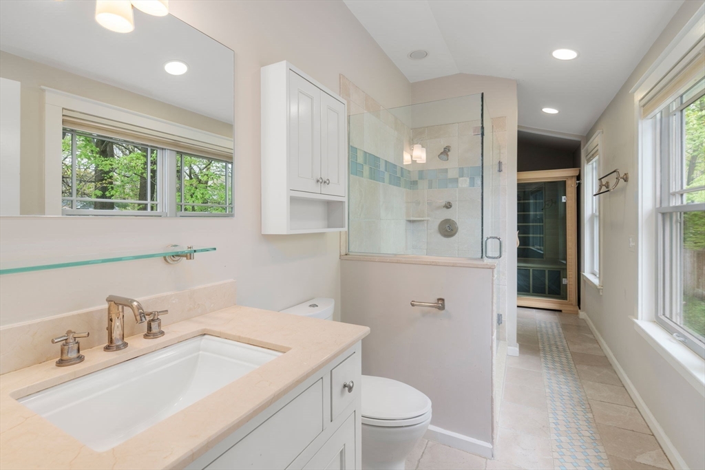 51 Avon Road Wellesley, MA 02482 - Photo 16 of 26 a bathroom with a sink a toilet a large mirror and shower