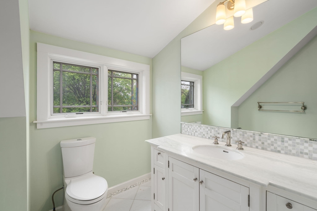 51 Avon Road Wellesley, MA 02482 - Photo 22 of 26 a bathroom with a toilet a sink a mirror a window and vanity