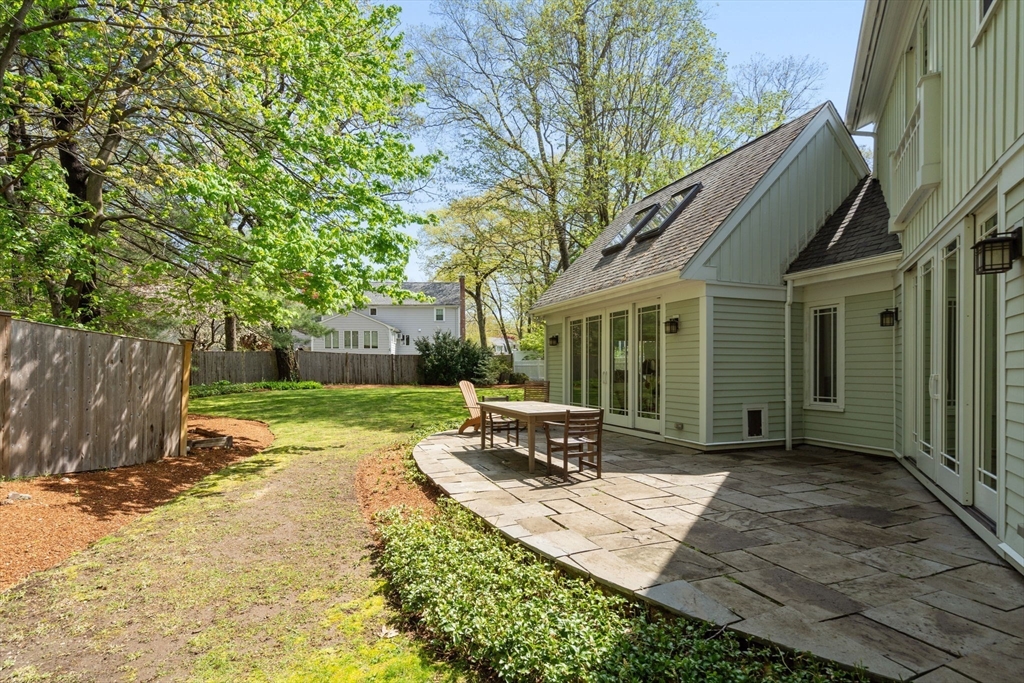 51 Avon Road Wellesley, MA 02482 - Photo 26 of 26 a view of a patio with table and chairs a barbeque with wooden fence and floor