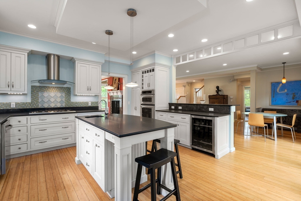 51 Avon Road Wellesley, MA 02482 - Photo 4 of 26 a kitchen with stainless steel appliances kitchen island granite countertop a stove a sink and a refrigerator
