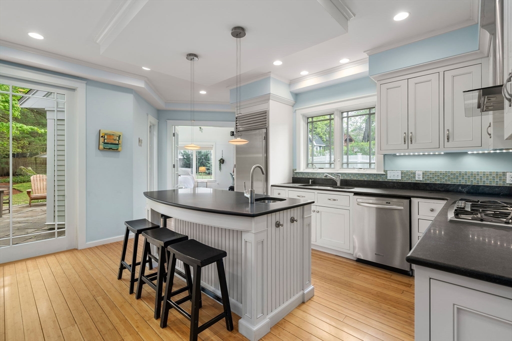 51 Avon Road Wellesley, MA 02482 - Photo 5 of 26 a kitchen with stainless steel appliances granite countertop wooden floor a sink cabinets and a wooden floor
