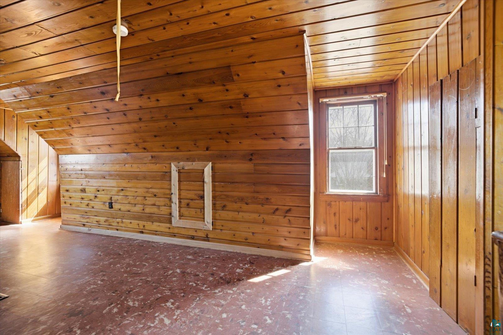 709 Michigan Street Hibbing, MN 55746 - Photo 38 of 47 Additional living space featuring tile patterned floors, wood walls, and wood ceiling