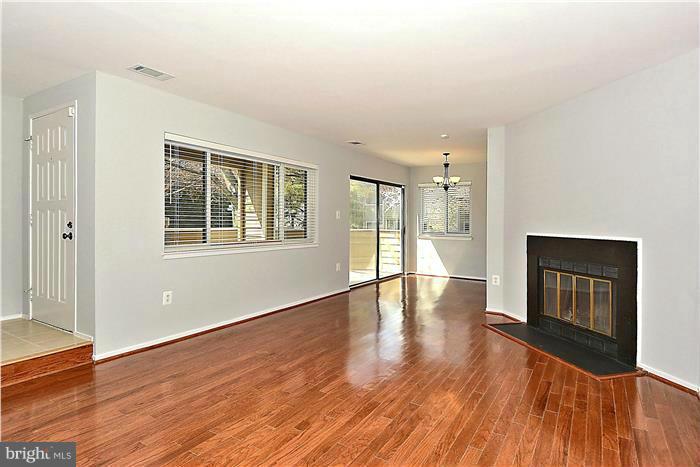 11049 Villaridge Court, Unit A Reston, VA 20191 - Photo 3 of 27 Hardwood floors with fireplace